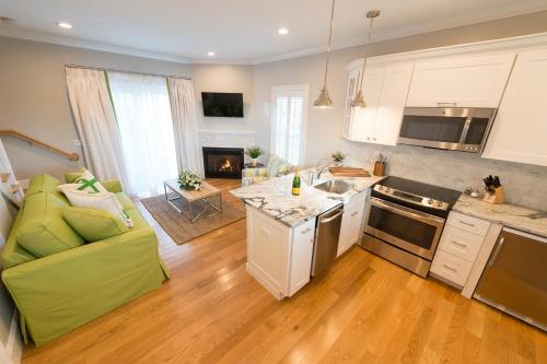 a kitchen and living room with a green couch at The East Island Reserve Hotel in Middletown