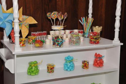 a white shelf filled with lots of colorful candy containers at Hotel Salobreña Suites in Salobreña