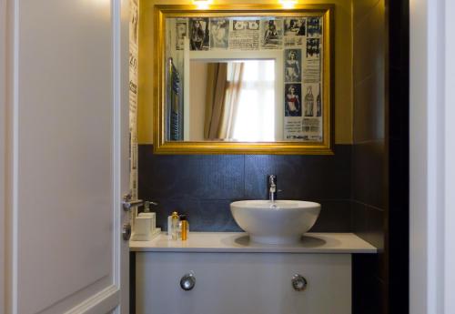 a bathroom with a sink and a mirror at Golden Stars Budapest Apartments in Budapest