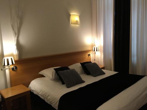 a bedroom with a bed with two pillows on it at Chambres D'Hotes Rekko in Maastricht