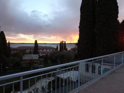 a view of a sunset from a balcony at Hotel Meridiana in Sirmione