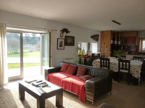 a living room with a couch and a table at Moleiro's Country House in Esposende