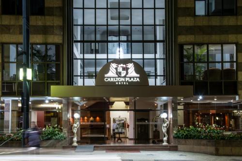 a building with a sign on the front of it at Hotel Carlton Plaza in Poços de Caldas