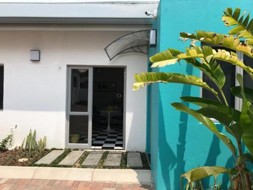 a blue and white house with a doorway at HP Twelve Accommodation in Nelspruit