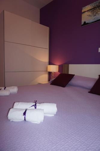 a bedroom with a bed with three towels on it at Tomena apartments in Trogir