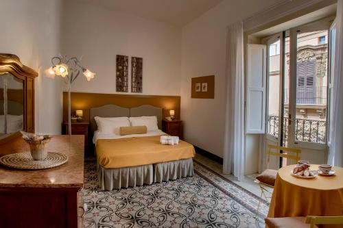 a hotel room with a bed and a balcony at Ai Lumi in Trapani