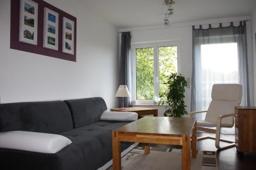 a living room with a couch and a coffee table at FeWo Strohbach in Meißen