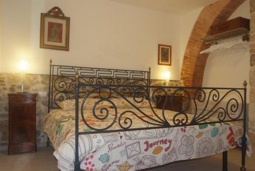 a bedroom with a black metal bed in a room at Piccola corte in Ascoli Piceno