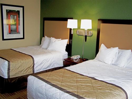 a hotel room with two beds and a phone at Extended Stay America Suites - Mobile - Spring Hill in Mobile