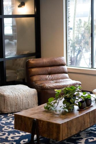 a living room with a leather chair and a coffee table at Hotel Becket, BW Signature Collection in South Lake Tahoe