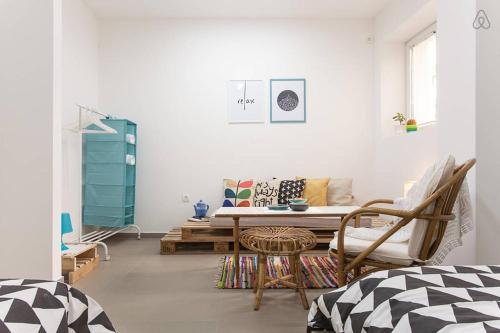 a living room with a couch and a table at Colors Apartment in Skopje