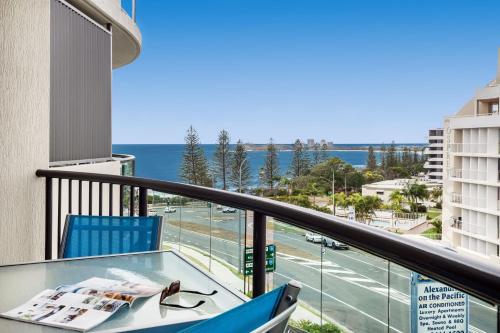 a balcony with a table and a view of the ocean at Alexandra on the Pacific in Mooloolaba