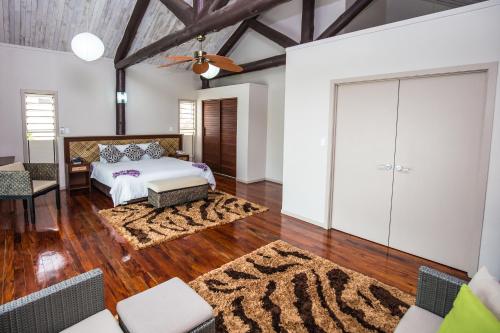 a bedroom with a bed and a rug at Saletoga Sands Resort & Spa in Matatufu