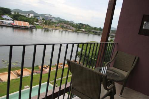 a balcony with a view of a river at The Glory River Kwai Hotel in Kanchanaburi