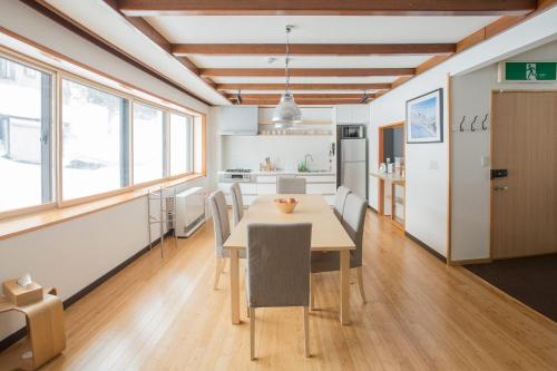 a kitchen and dining room with a table and chairs at Nozawa Central in Nozawa Onsen