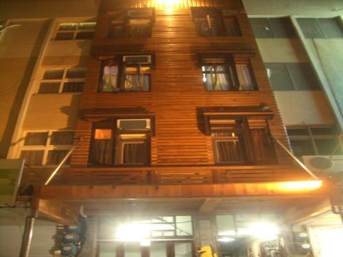 a tall wooden building with a lot of windows at Sha Feng Lu Dian in Magong