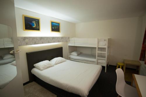a bedroom with a bed and two bunk beds at hôtel QUICK Palace Tours Nord in Tours