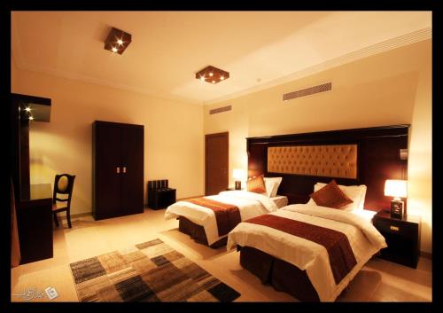 a large hotel room with two beds in a room at Taraf Yanbu in Yanbu