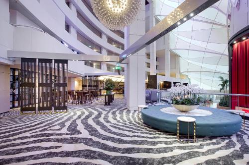 a lobby of a building with a table in the middle at The Star Grand at The Star Gold Coast in Gold Coast