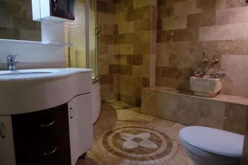 a bathroom with a sink and a toilet and a shower at Anatolia cave hotel Pension in Goreme