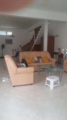 a living room with a couch and a table at Lacase Silverpalm in Pereybere