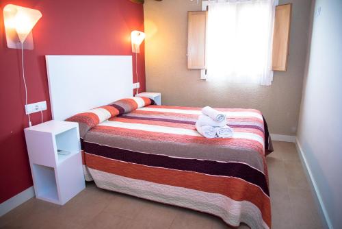 a hotel room with a bed with towels on it at Apartamentos Bergantes in Ortells