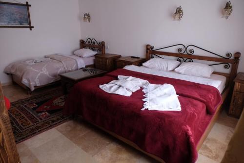 a bedroom with two beds with towels on them at Anatolia cave hotel Pension in Goreme