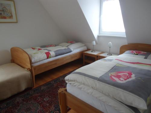 a bedroom with two beds and a window at Ferienhaus Gumann in Nuremberg