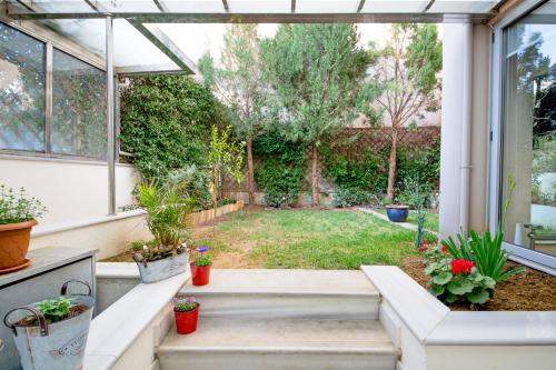 a garden with potted plants in a greenhouse at Comfy Boutique Hotel in Kalamata