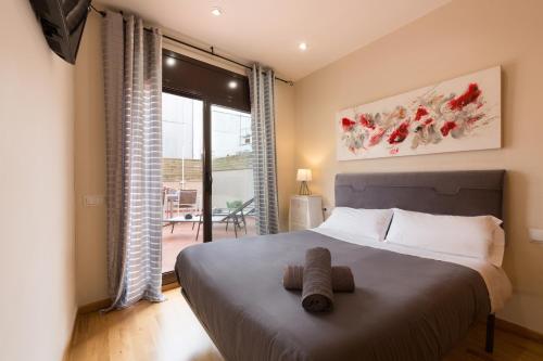a bedroom with a bed and a large window at Matarolux 8 in Mataró