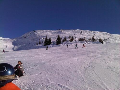 a group of people skiing down a snow covered slope at L'arpont in Champagny-en-Vanoise