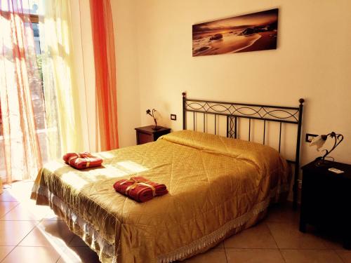 a bedroom with a bed with two bags on it at Aloha House in Formia