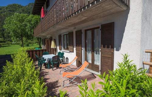 a patio with chairs and a table on the side of a building at Casa Lori Green Holiday in Ledro