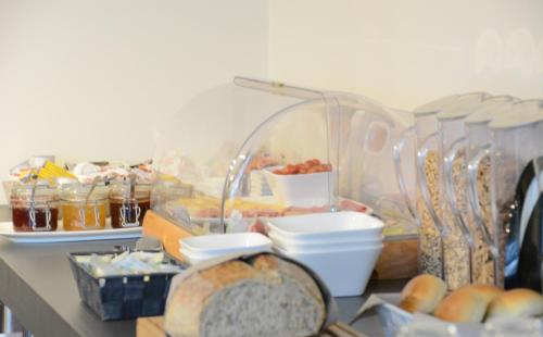 a table with a bunch of bread and other foods at Abalona Hotel & Apartments in Dendermonde