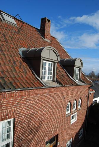 a roof of a brick building with windows on it at Halmstad Hotell & Vandrarhem Kaptenshamn in Halmstad