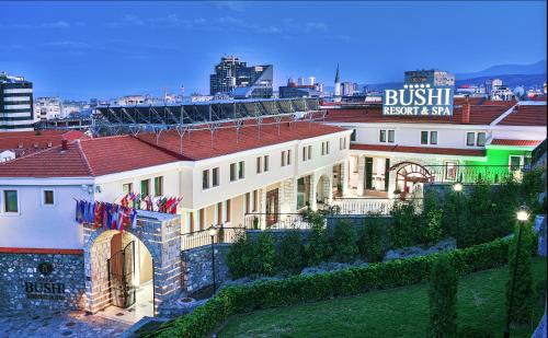 a building with a sign on top of it at Bushi Resort & SPA in Skopje