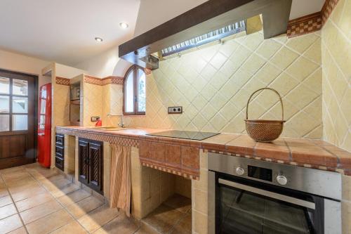 a large kitchen with a counter and a sink at Villa Almond in San Antonio Bay