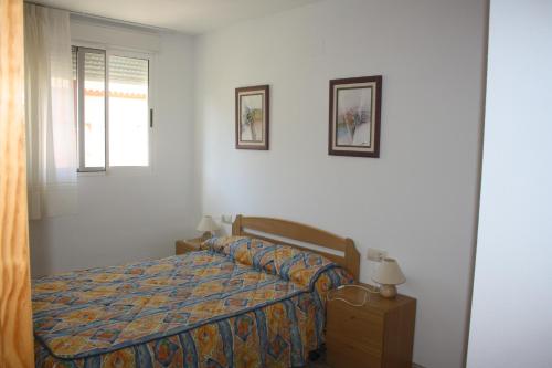 מיטה או מיטות בחדר ב-Alquileres Figuerola Oasis Park