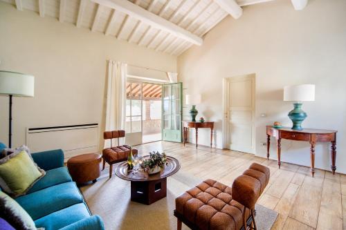 a living room with a blue couch and a table at Borgo Del Cabreo in Greve in Chianti