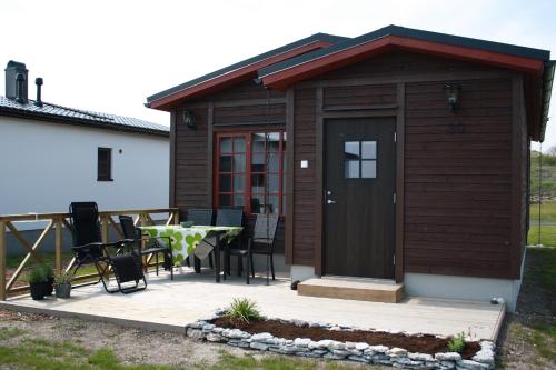 a small wooden shed with a table and chairs at Slite Strand resort in Slite