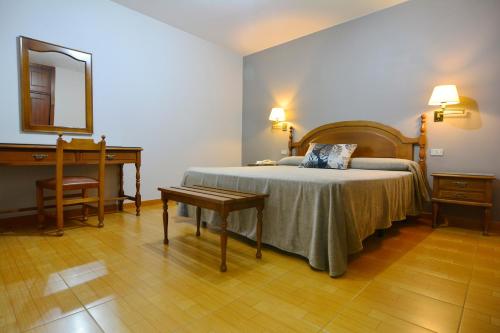 Ένα ή περισσότερα κρεβάτια σε δωμάτιο στο Hotel Jucamar