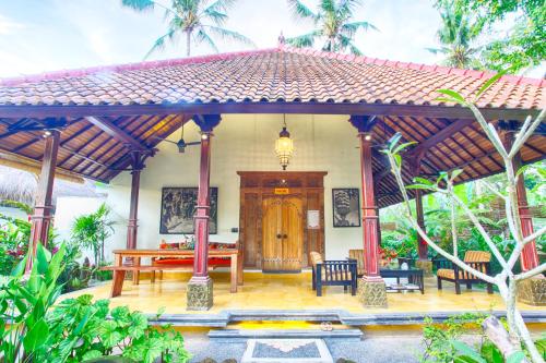 a house with a pavilion in a garden at Imagine Bali in Ubud