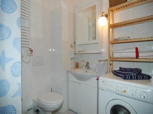 a bathroom with a washing machine and a sink at Apartment Royale in Dubrovnik