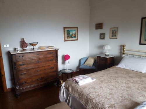 a bedroom with a bed and a wooden dresser at Clementina B&B in Brittoli