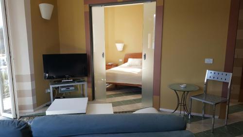 a living room with a couch and a television at Albergo Del Lago in Cannobio