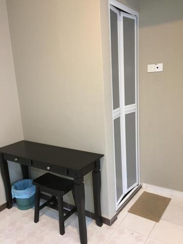 a black desk in a room with a window at Homestay Muar in Muar