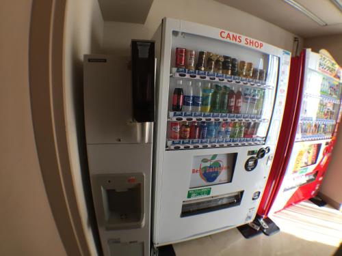 a coca cola vending machine with bottles of soda at Hotel Okhotsk Palace in Mombetsu