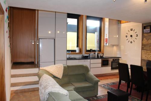 a living room with a couch and a kitchen at Casa São Dinis in Porto