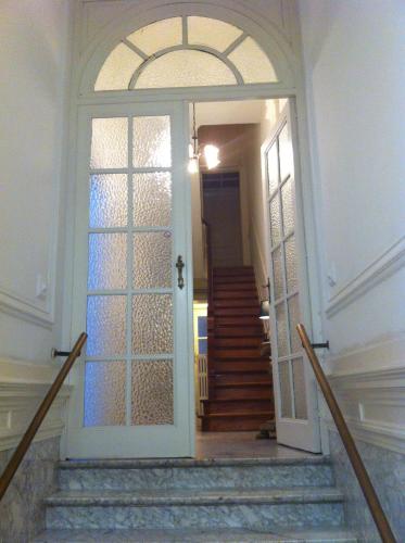 an entrance to a hallway with a door and stairs at Hotel Residence 18 in Brussels