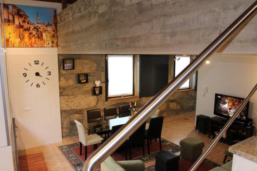 a dining room with a table and a clock on the wall at Casa São Dinis in Porto